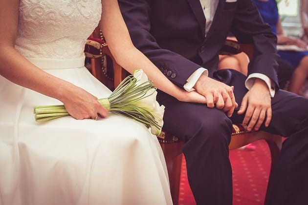 Bride and groom holding hands